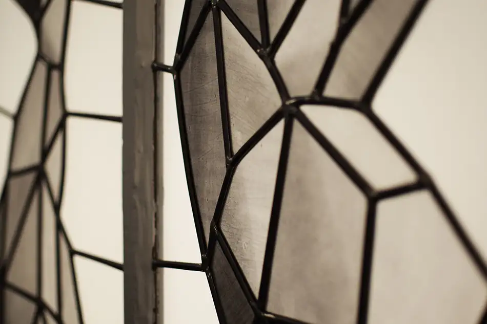 Detail of monochrome lead glazing with geometric pattern in old building entrance doors and fanlights
