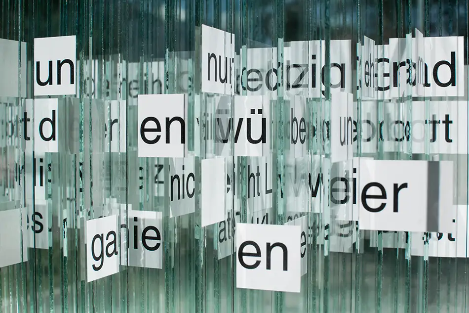 Detail of anamorphic glass art installation called 404 Ort with text by Martin Fritz
