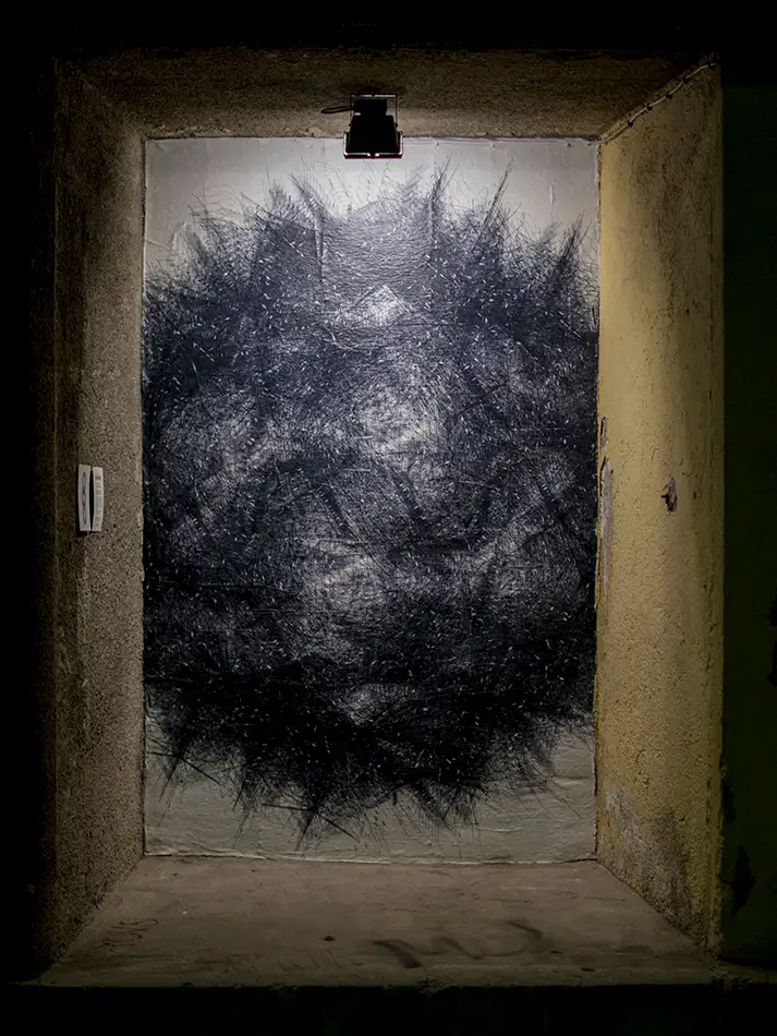 Street art paste-up of digitally printed vector drawing of an exposion-like black snowflake