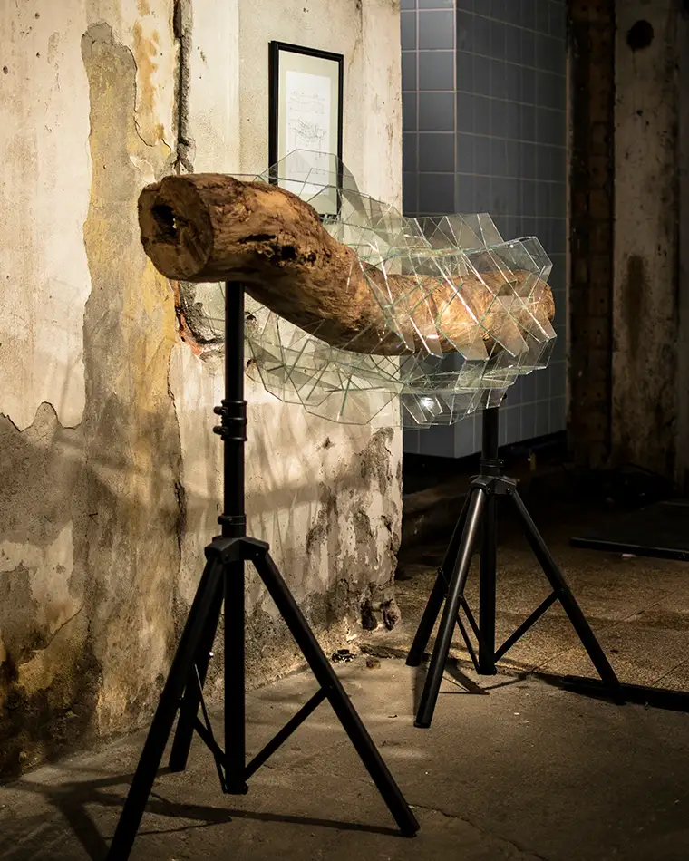 exhibition view at Bäckerei Kulturbackstube Innsbruck of geometric glass artwork that encapsulates a piece of driftwood