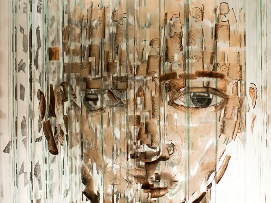 Anamorphic artwork - glass cube with four different images composed of image fragments - half assembled face