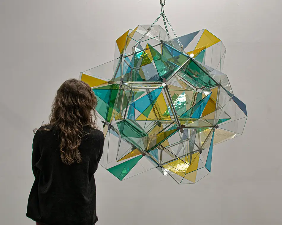 polyhedra - dodecahedron glass art object - with a person